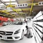 品質管理工程、完成検査場にて、光の反射を利用して細部まで検査作業中